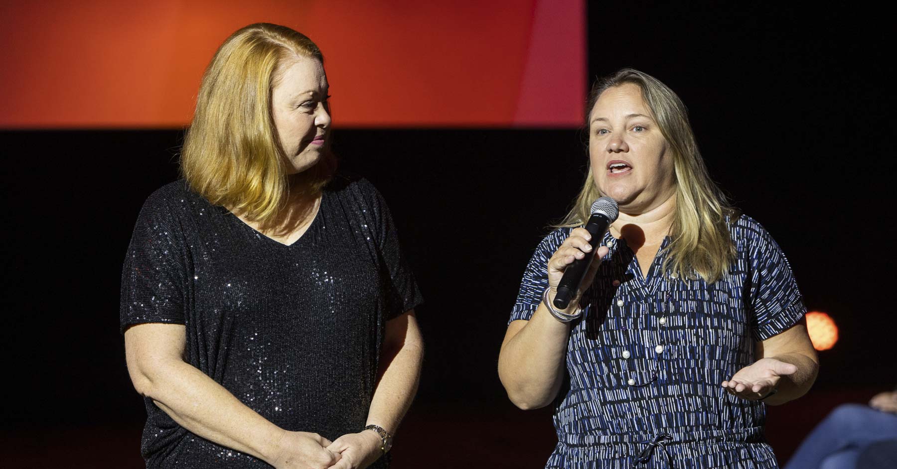 Two women giving a presentation on the main stage